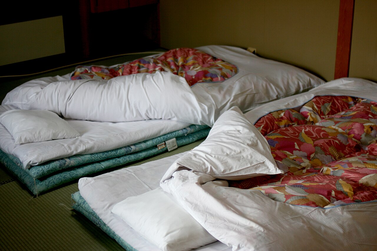 Two Japanese futons laid out on tatami in a ryokan
