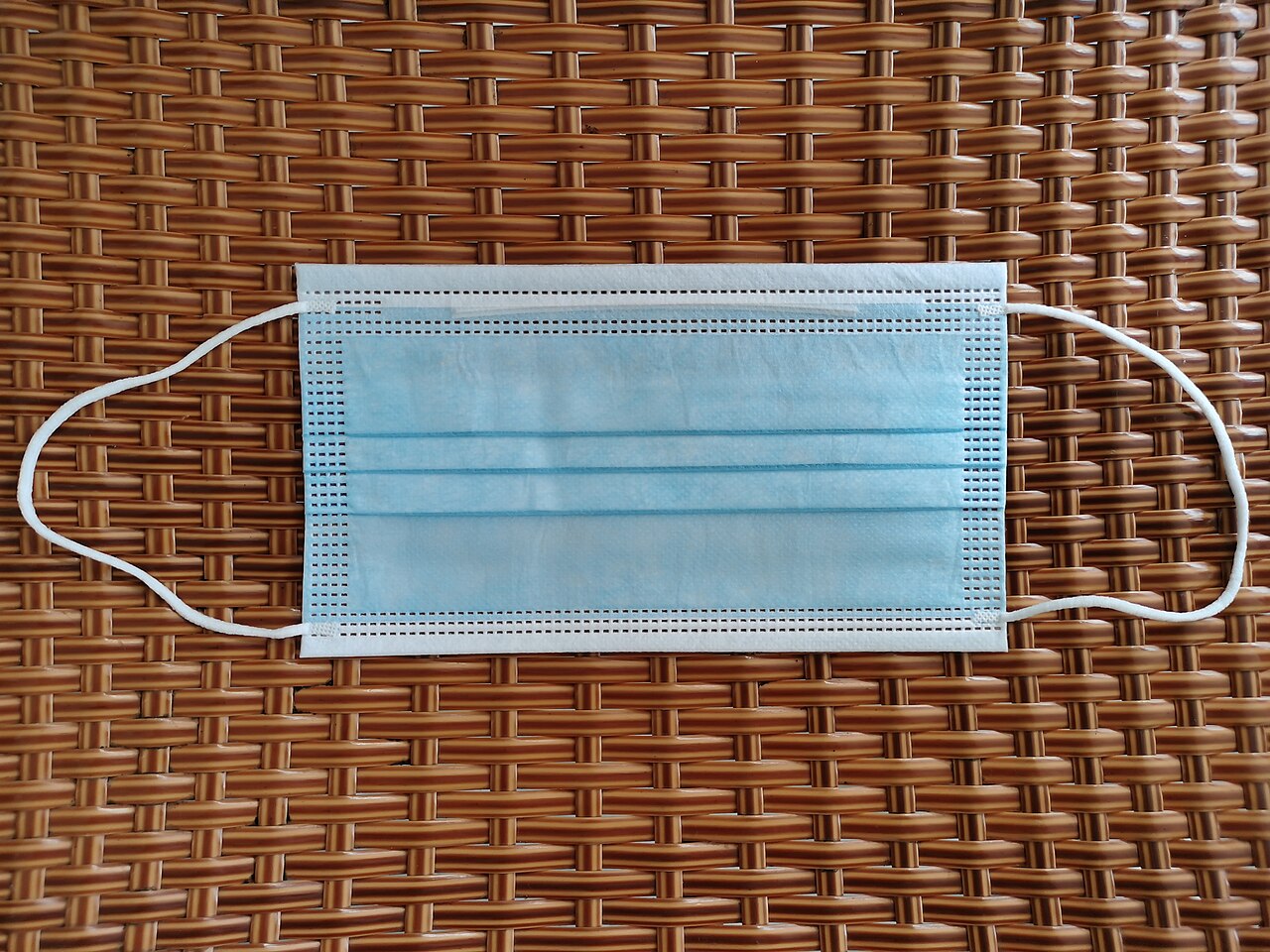 A blue disposable surgical face mask, the type seen daily across Japan in spring